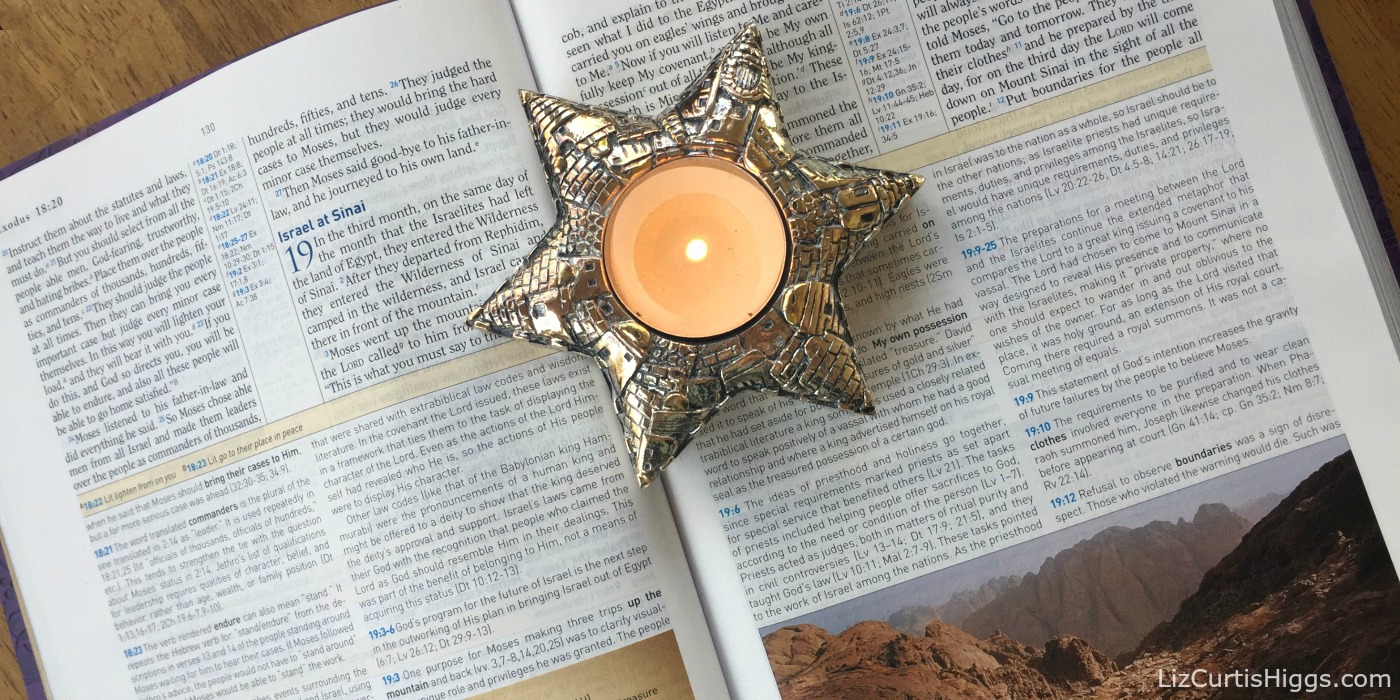 Jerusalem Candle on a Bible Open to Exodus